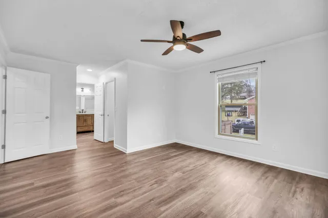 a view of a big room with wooden floor closet and windows