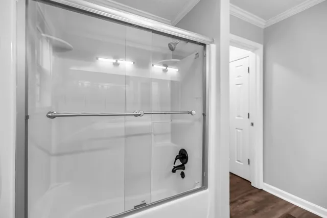 a bathroom with a glass shower door