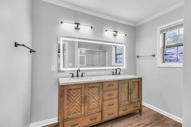 a bathroom with a double vanity sink and a mirror