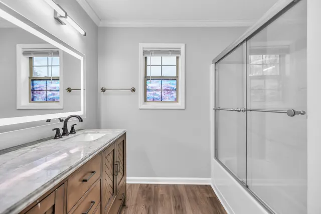 a bathroom with a double vanity sink a mirror and a shower