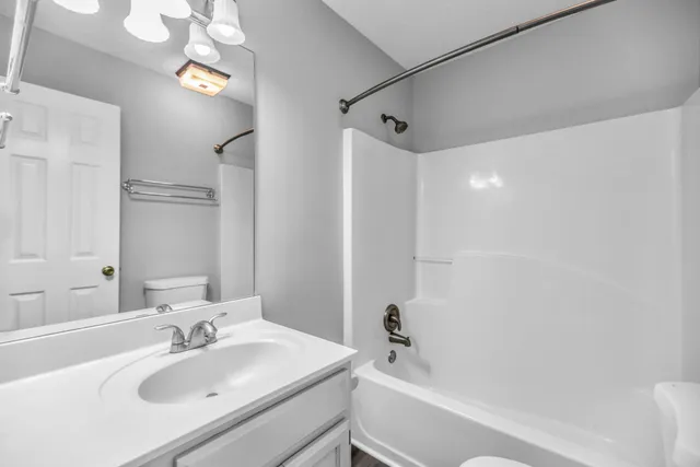 a bathroom with a sink a mirror and a bathtub