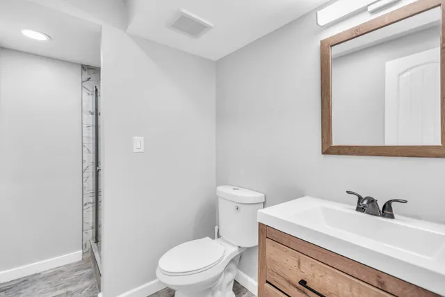 a bathroom with a sink toilet and shower