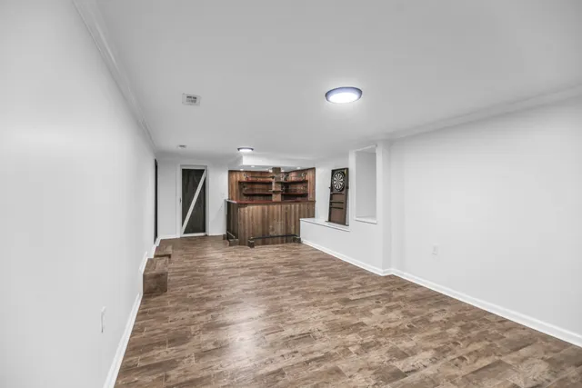 a view of empty room with kitchen