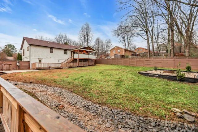 a backyard of a house with table and chairs