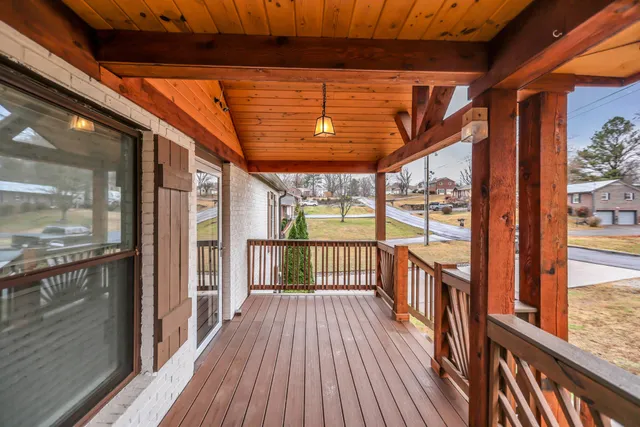 a view of a balcony with wooden floor