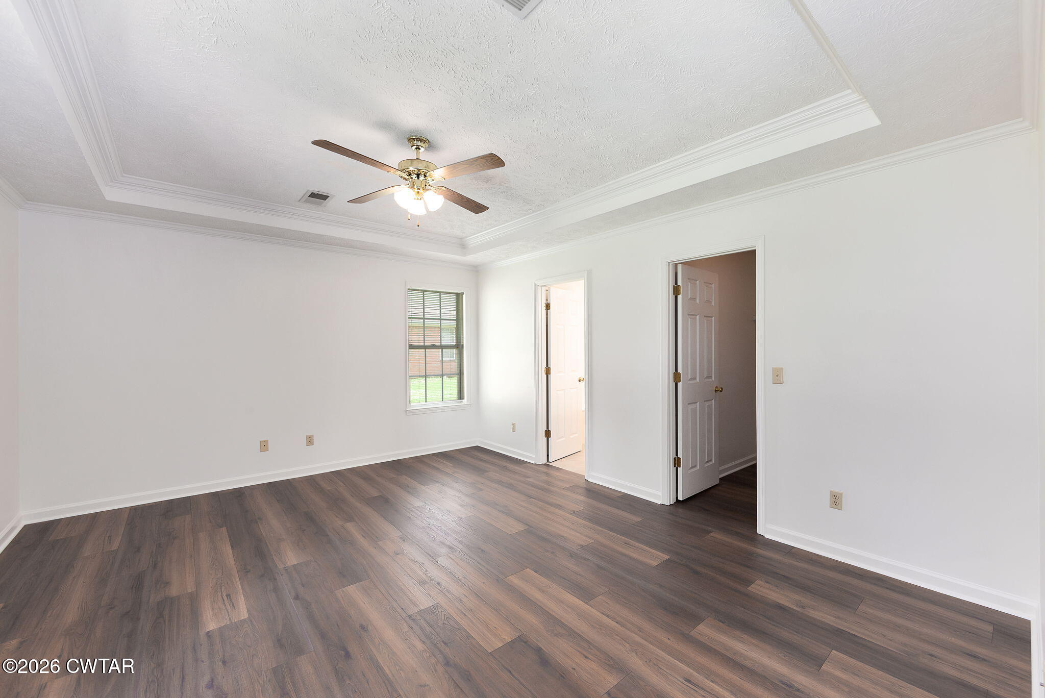 96 Sundown Drive Jackson, TN 38305 - Photo 14 of 28 an empty room with wooden floor and windows