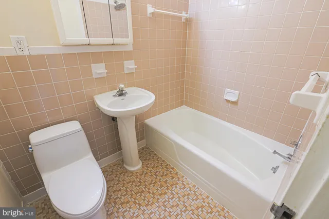 a white toilet sitting next to a white sink