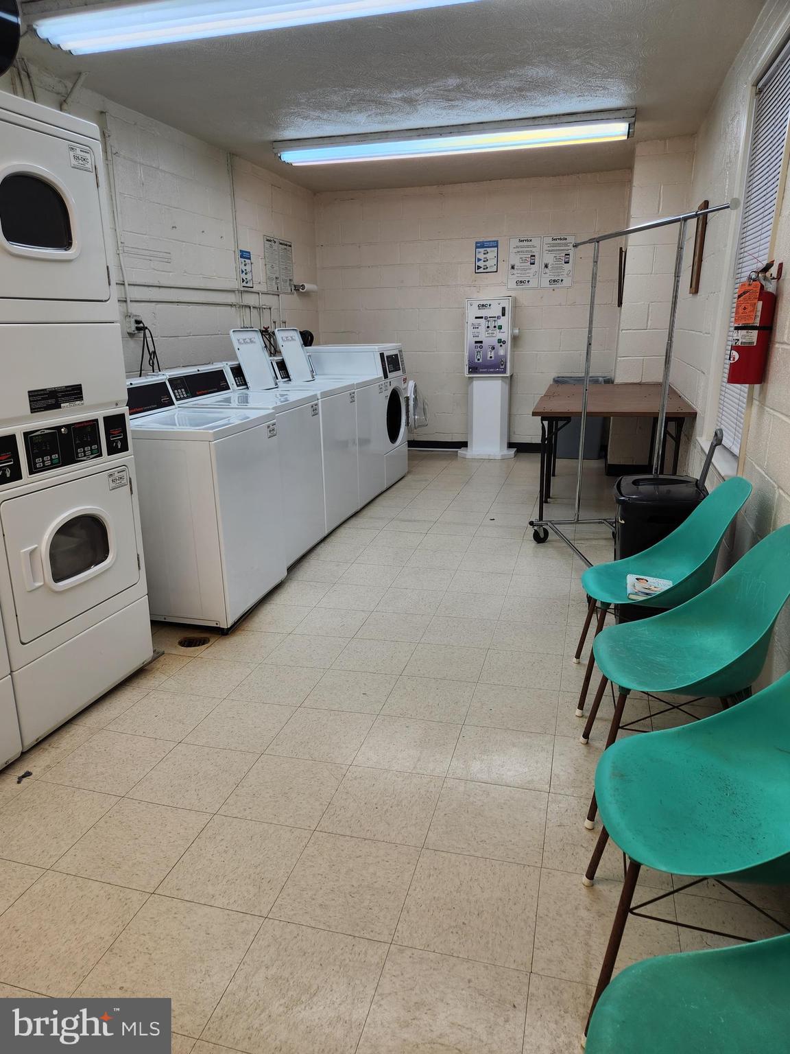 3535 Chevy Chase Lake Drive, Unit 310 Chevy Chase, MD 20815 - Photo 35 of 40 a utility room with multiple dryer and washer