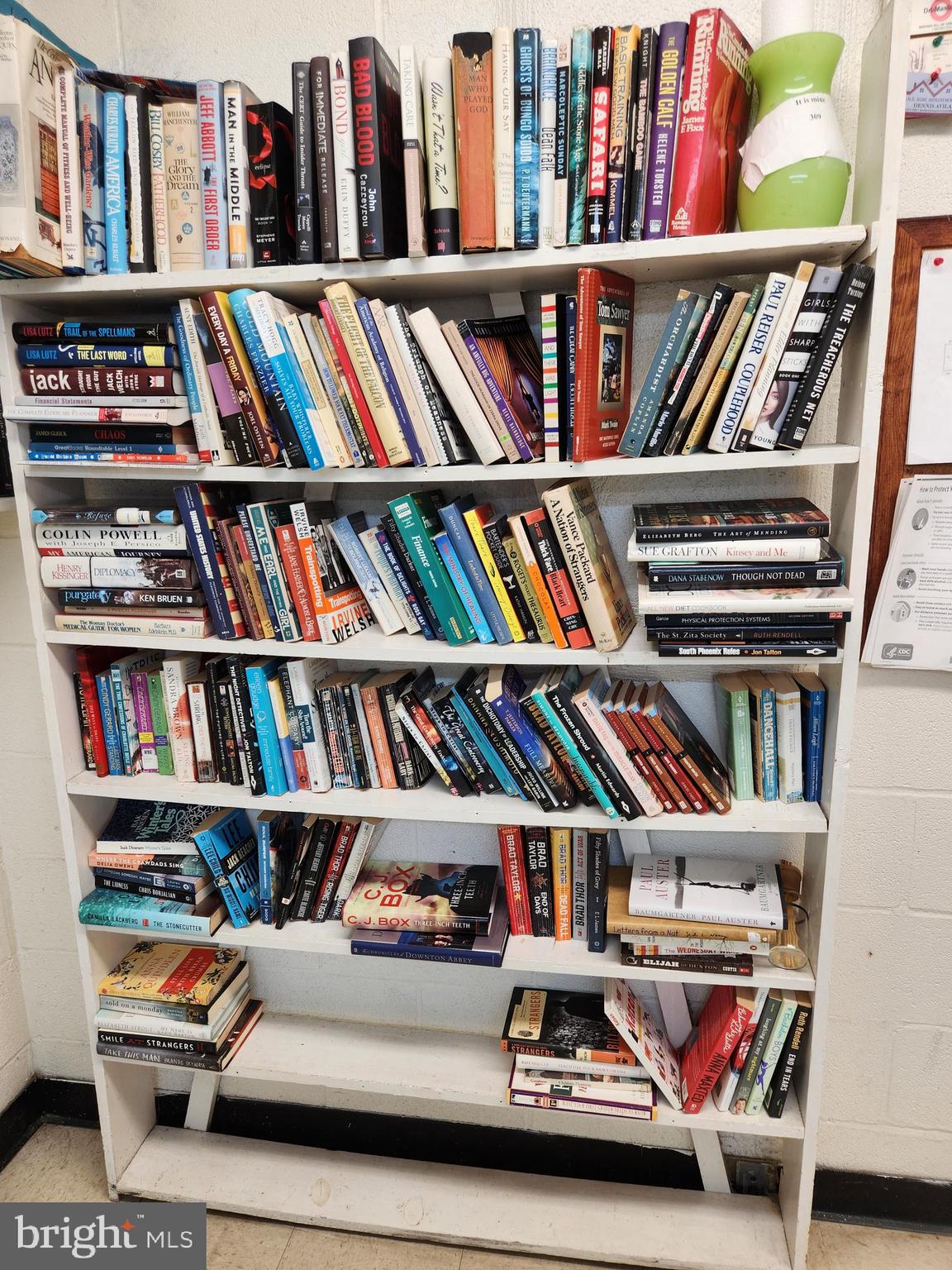 3535 Chevy Chase Lake Drive, Unit 310 Chevy Chase, MD 20815 - Photo 36 of 40 a living room with lots of books
