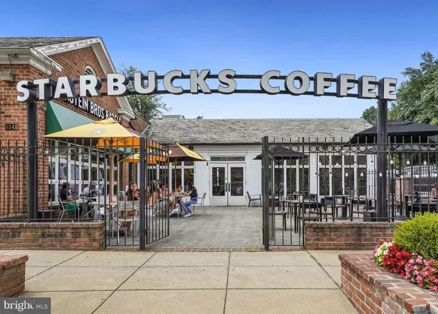 a view of a book shop with a lot of flowers