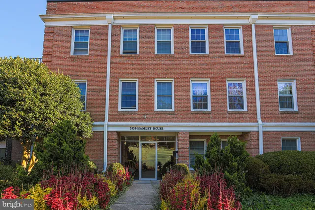 a front view of a house with a yard and outdoor seating