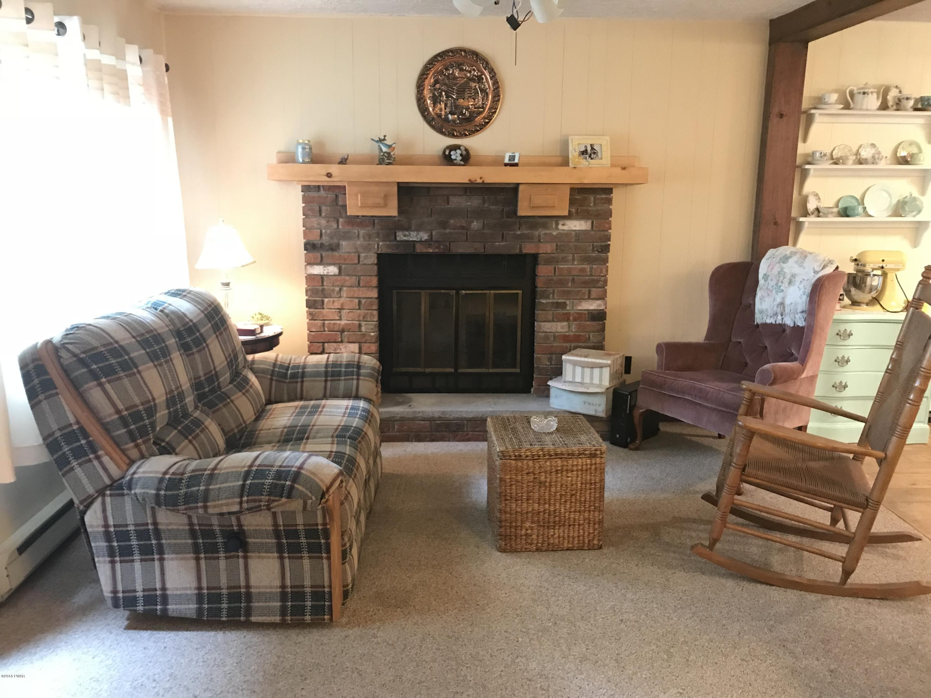 3187 Northgate Road Lake Ariel, PA 18436 - Photo 7 of 29 a living room with furniture and a fireplace