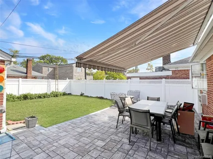 a view of a patio with table and chairs