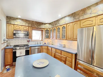a kitchen with a stove a sink and a refrigerator