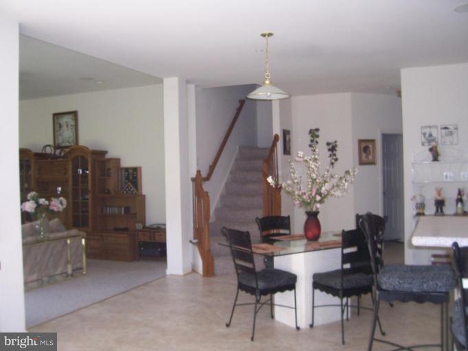 6905 Golden Raintree Court Clinton, MD 20735 - Photo 10 of 25 Rear Staircase and Eating Area