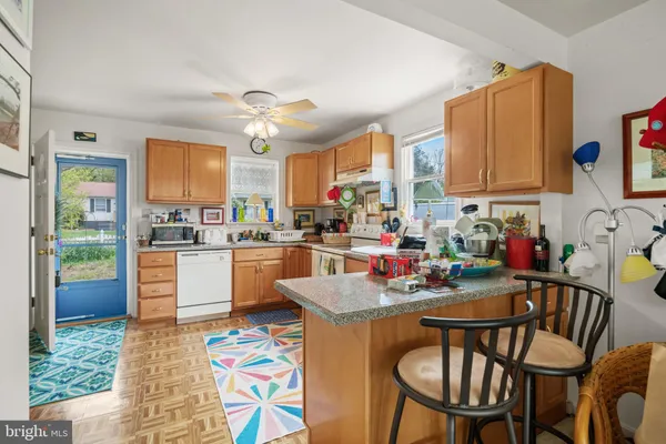 a kitchen with kitchen island a white cabinets and window
