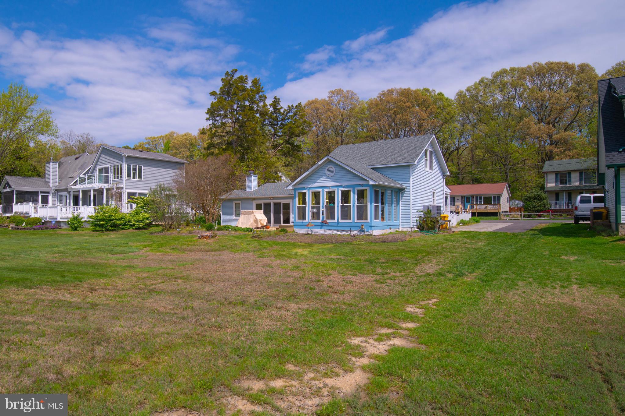 5930 Sneed Drive Deale, MD 20751 - Photo 8 of 38 a front view of a house with a garden