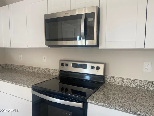 a kitchen with a stove and a microwave