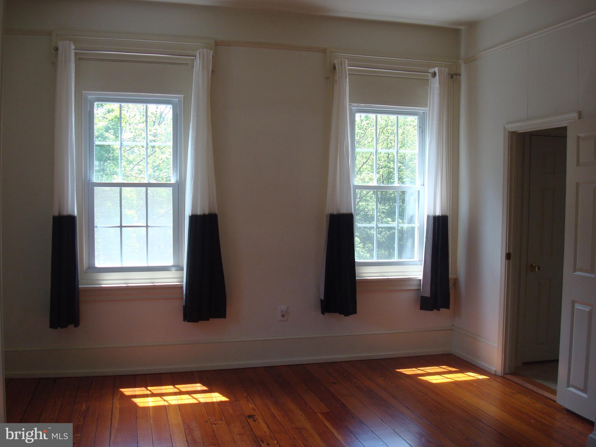 514 Spring Grove Lane, Unit 3 West Chester, PA 19382 - Photo 12 of 35 a view of empty room with wooden floor and fan