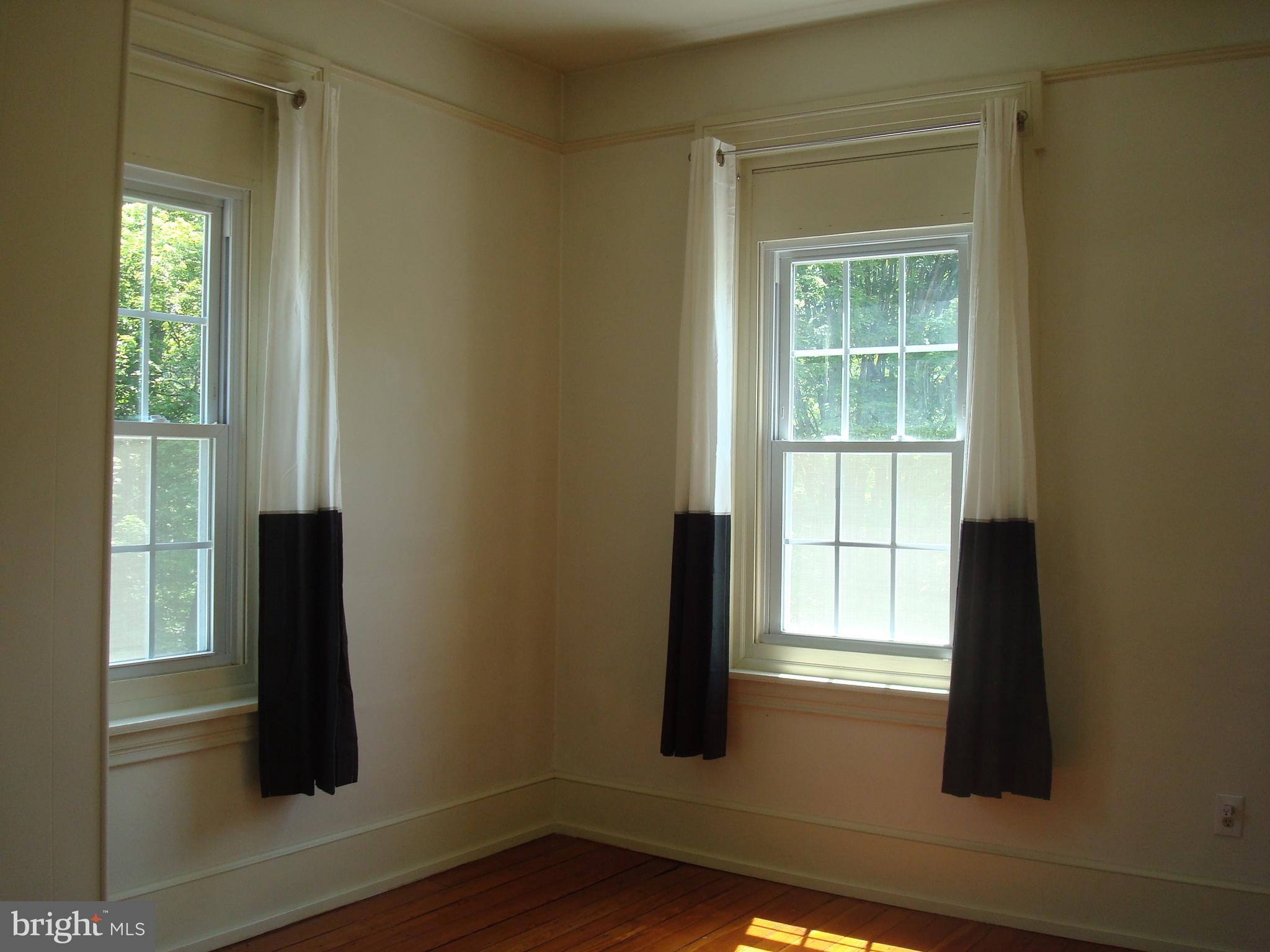 514 Spring Grove Lane, Unit 3 West Chester, PA 19382 - Photo 13 of 35 a view of an empty room with wooden floor and a window
