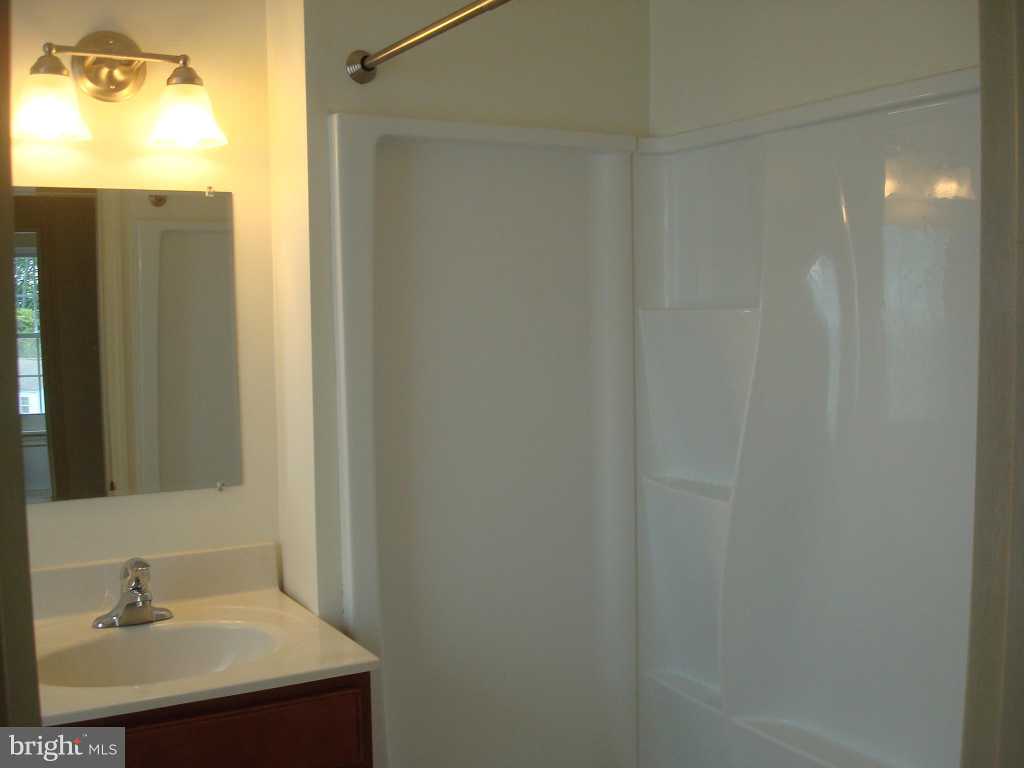 514 Spring Grove Lane, Unit 3 West Chester, PA 19382 - Photo 16 of 35 a bathroom with a sink and a mirror