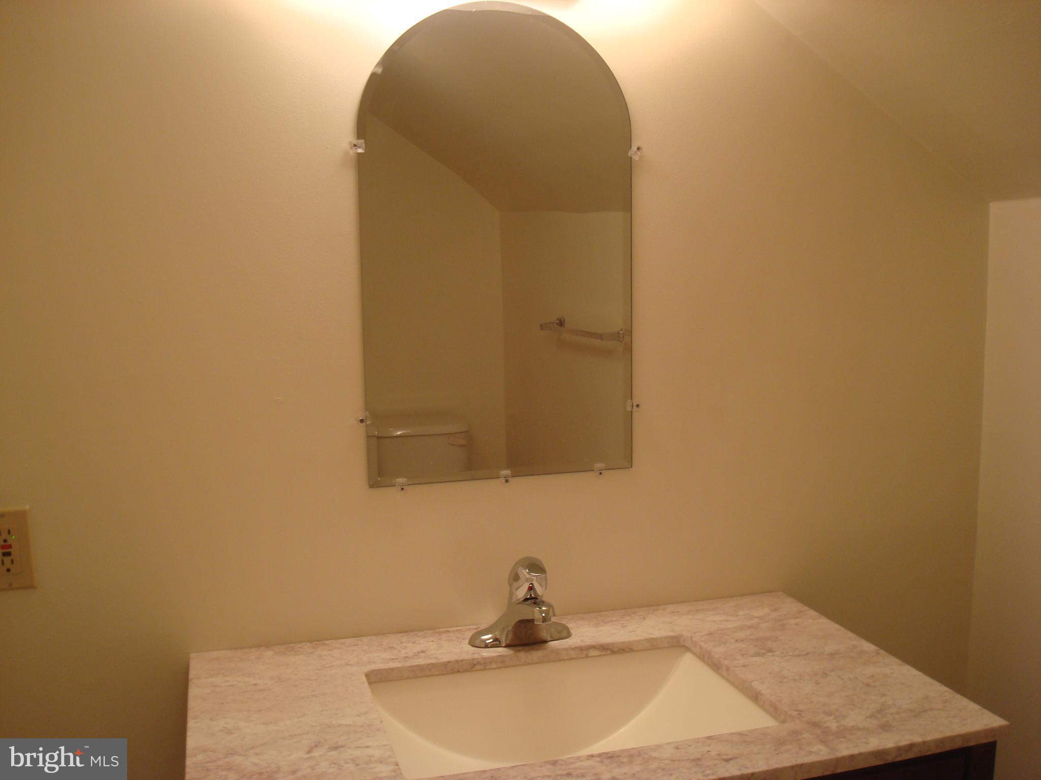 514 Spring Grove Lane, Unit 3 West Chester, PA 19382 - Photo 22 of 35 a bathroom with a sink and a mirror