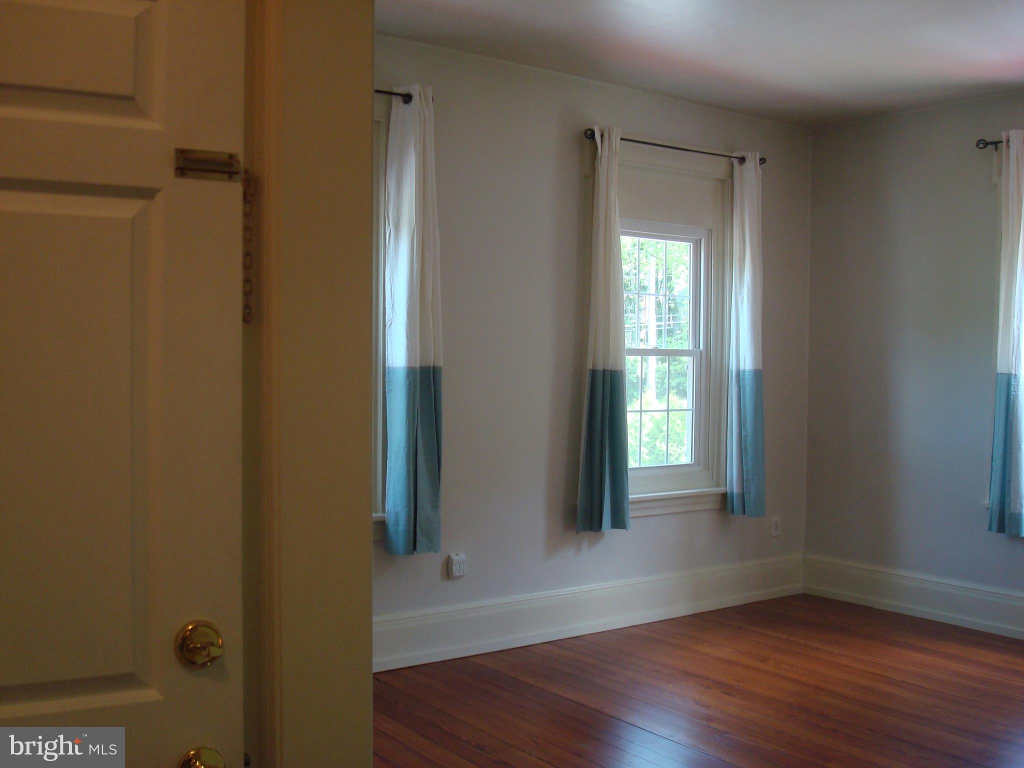 514 Spring Grove Lane, Unit 3 West Chester, PA 19382 - Photo 26 of 35 a view of an empty room with wooden floor and a window