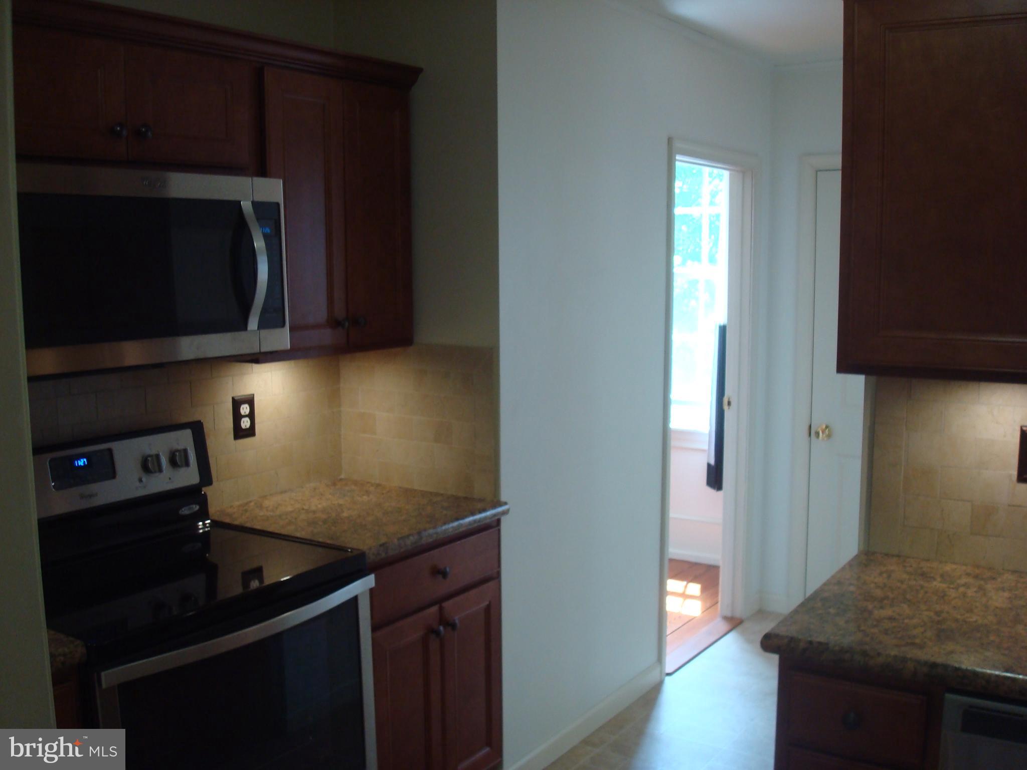 514 Spring Grove Lane, Unit 3 West Chester, PA 19382 - Photo 8 of 35 a kitchen with a sink a stove and cabinets