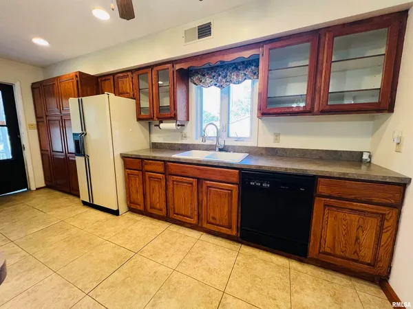 a view of kitchen with furniture and wooden cabinets