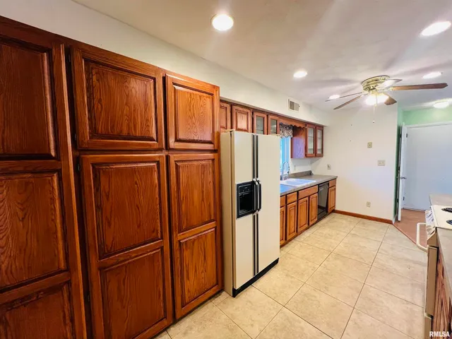a spacious bathroom with a granite countertop sink and a mirror