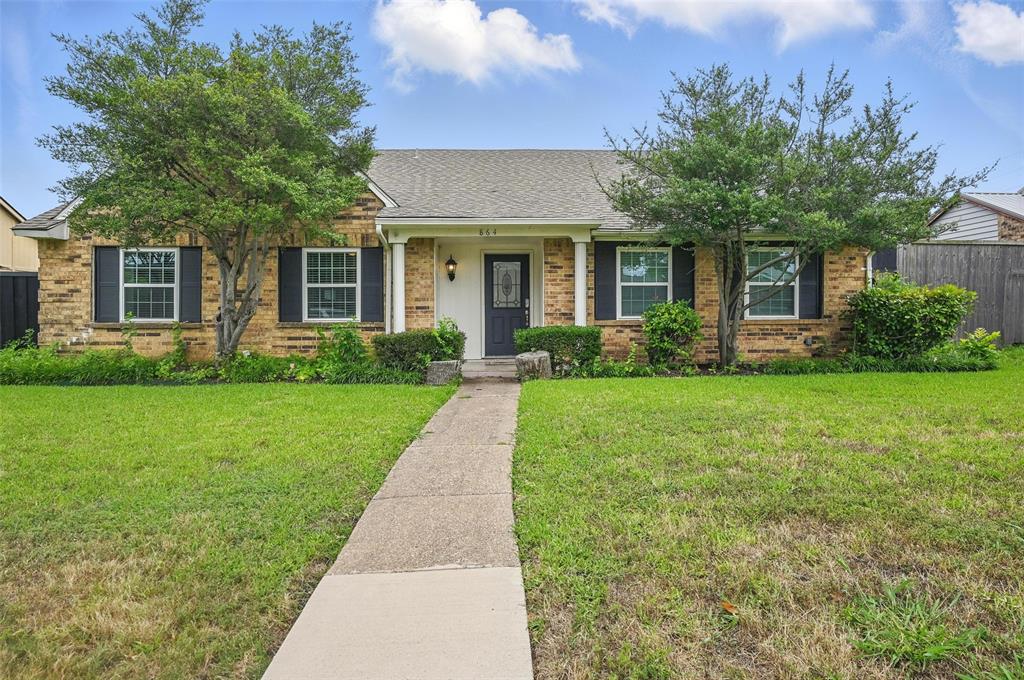 View of front of house with brick siding and a shingled roof