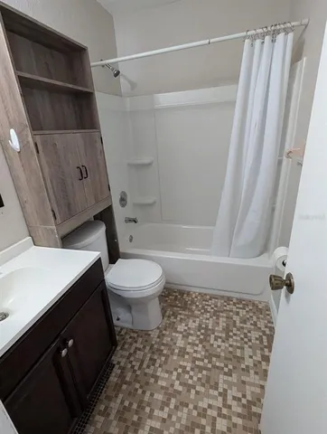 a bathroom with a toilet a sink and shower