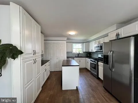 a kitchen with a refrigerator sink and microwave