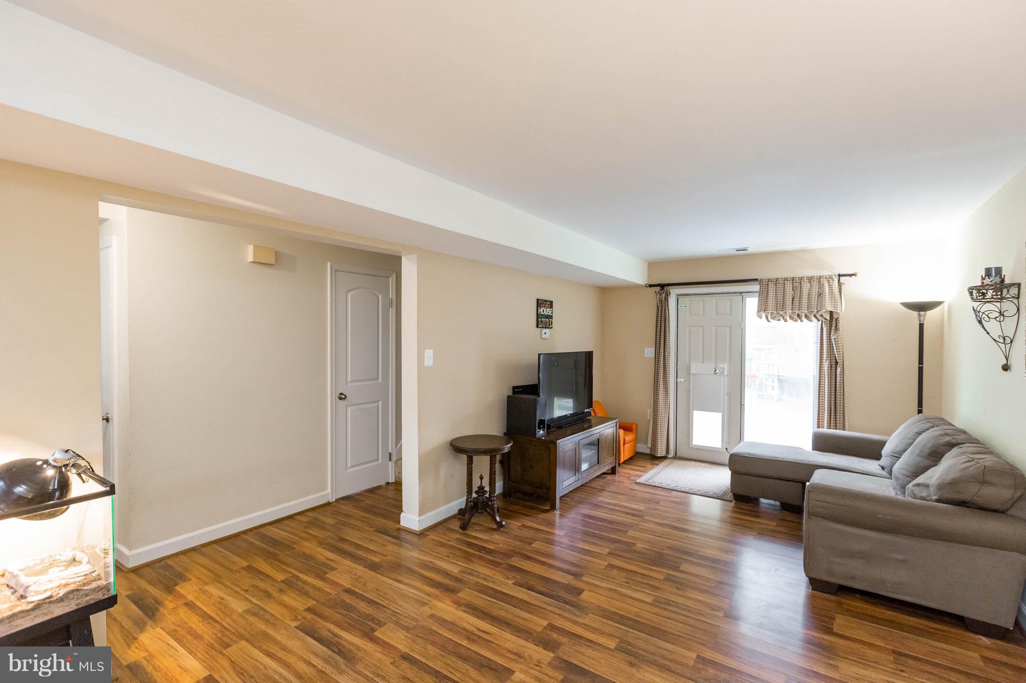 14308 Lindendale Road Woodbridge, VA 22193 - Photo 19 of 39 a living room with furniture and a wooden floor