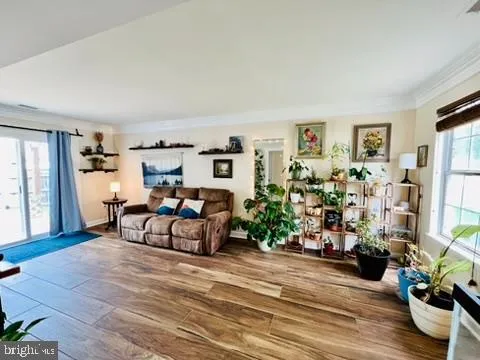 a living room with furniture a dining table and kitchen view