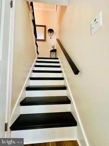 a bedroom with a chair and a window