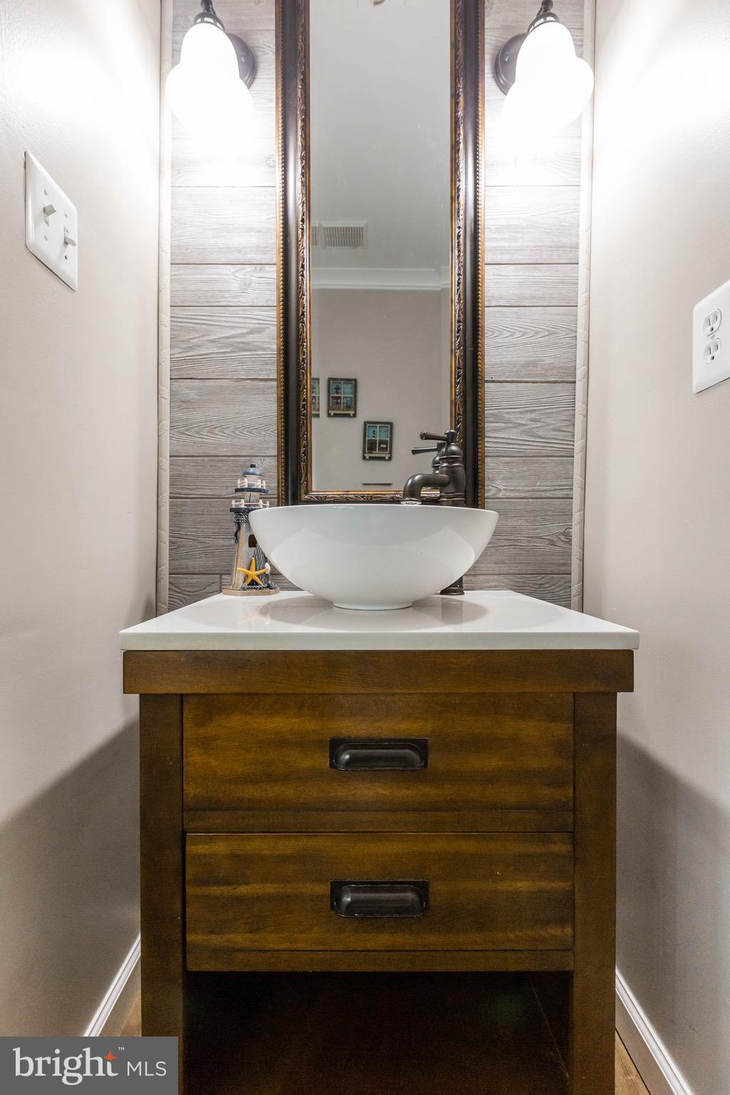14308 Lindendale Road Woodbridge, VA 22193 - Photo 28 of 39 a bathroom with a sink and a mirror