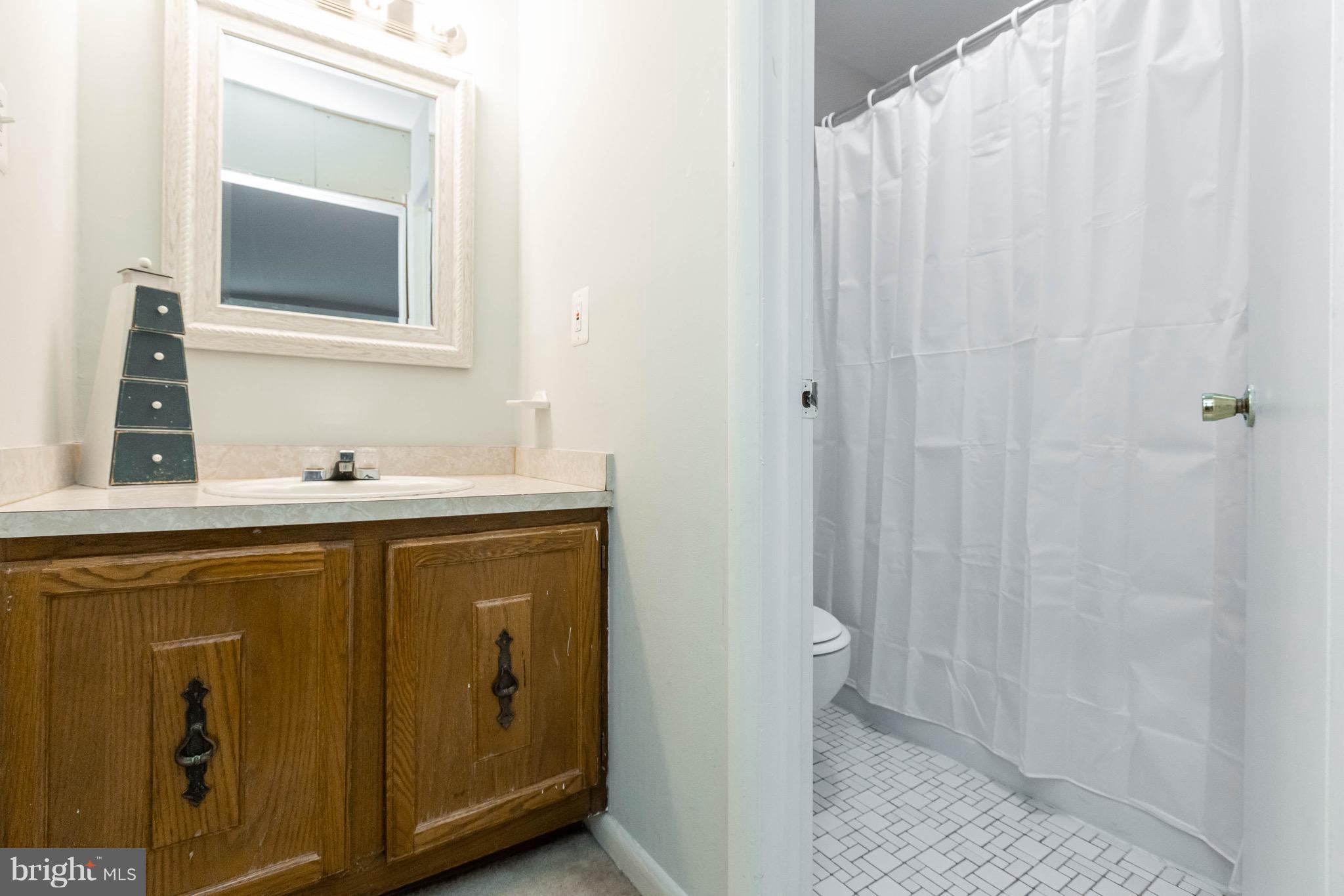 14308 Lindendale Road Woodbridge, VA 22193 - Photo 6 of 39 a bathroom with a sink and a mirror