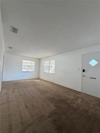 a view of an empty room and a window