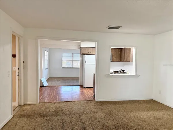 an empty room with windows and cabinet