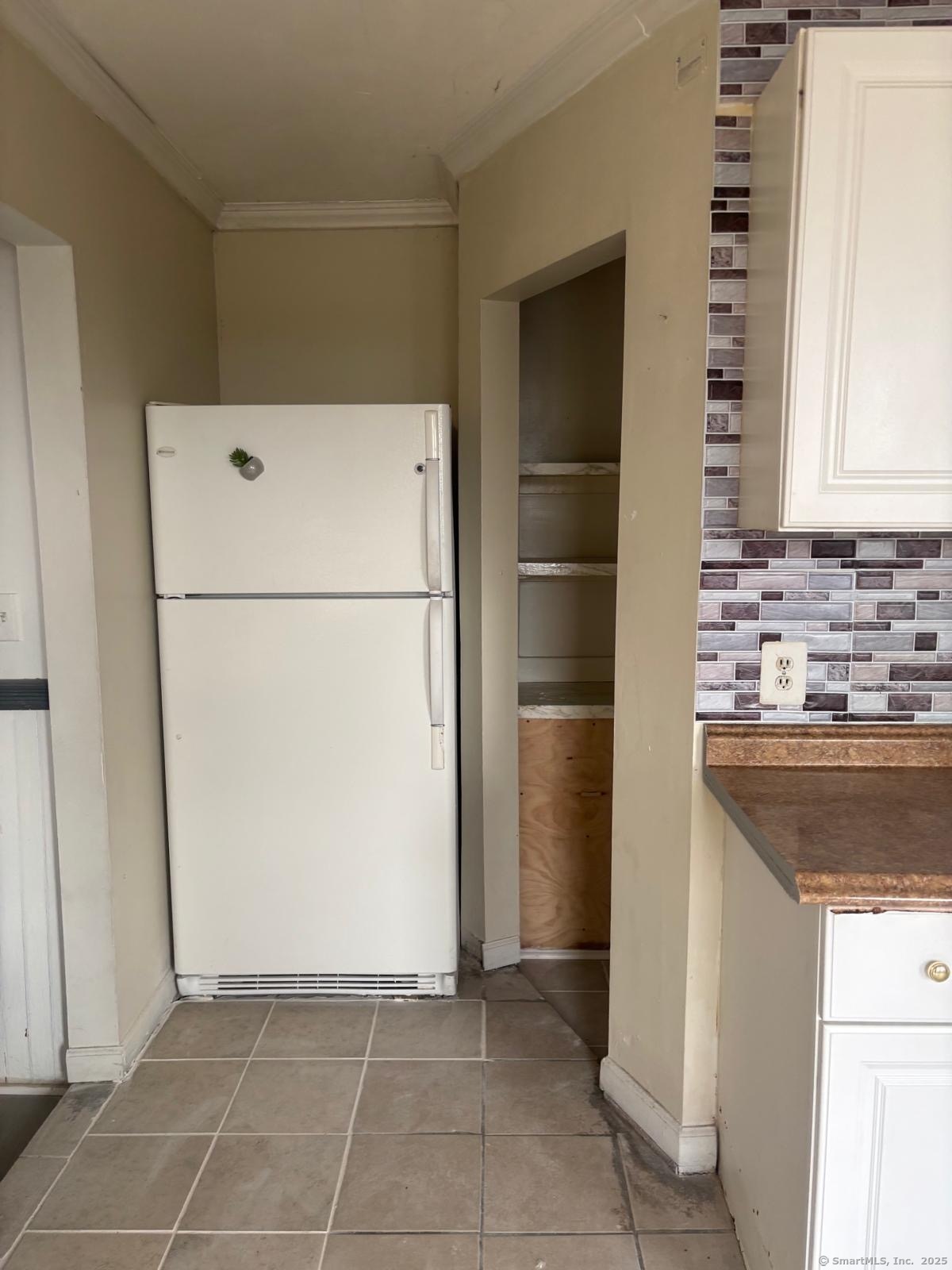 1308 East Main Street Waterbury, CT 06705 - Photo 2 of 10 a white refrigerator freezer and a stove sitting inside of a kitchen