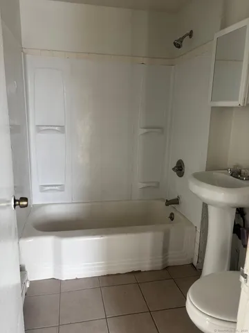 a bathroom with a bathtub and toilet
