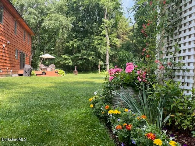 a view of a house with a big yard and potted plants