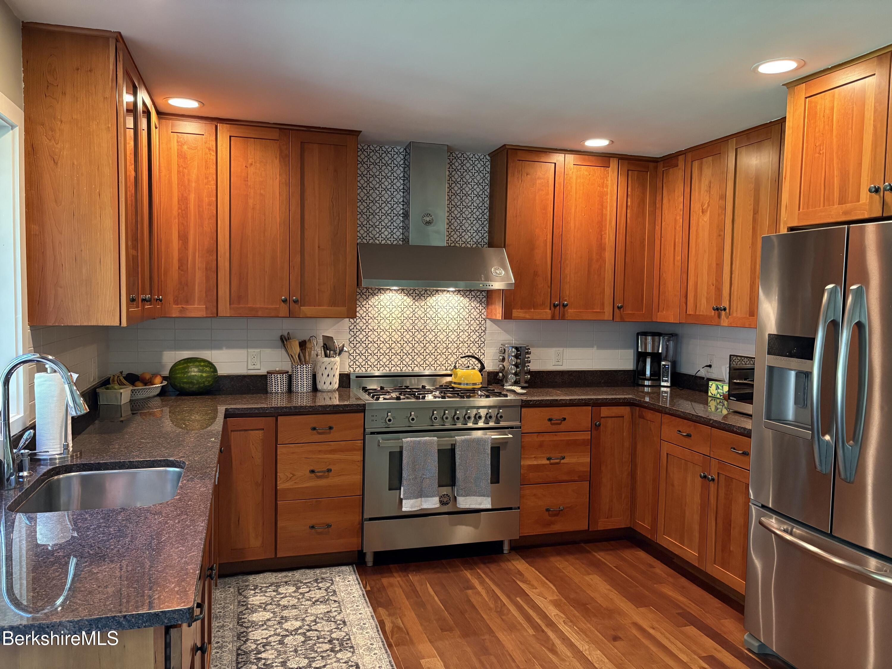 188 Hillsdale Road Egremont, MA 01230 - Photo 4 of 32 a kitchen with stainless steel appliances granite countertop a stove a sink dishwasher and cabinets with wooden floor