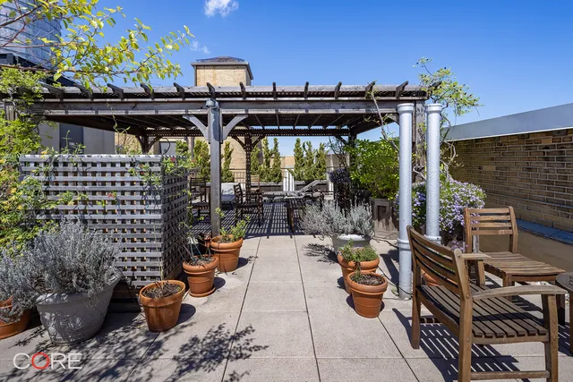 a view of balcony with chairs and potted plants