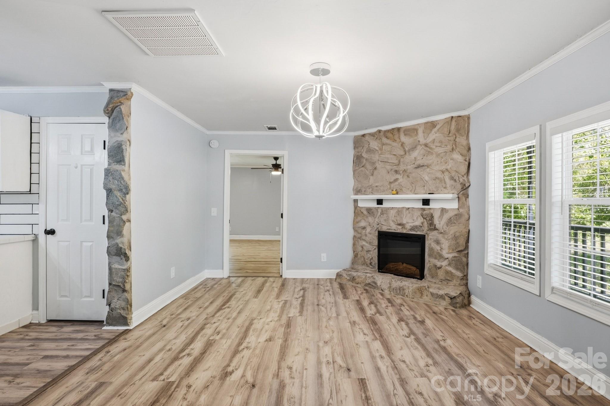 116 Springdale Drive York, SC 29745 - Photo 4 of 32 a view of empty room with wooden floor fireplace and windows
