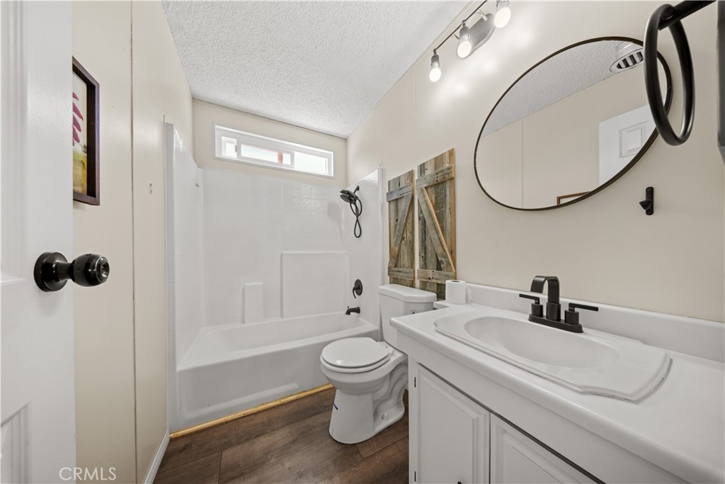 2033 Hollister Road Pinon Hills, CA 92372 - Photo 15 of 25 a bathroom with a sink a toilet and a mirror