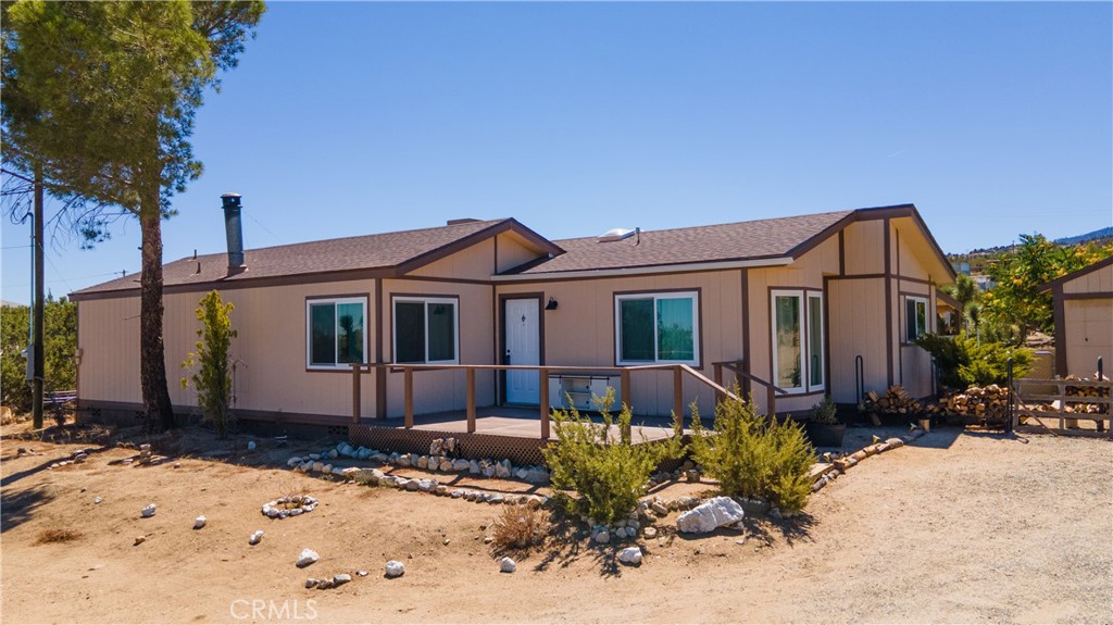 2033 Hollister Road Pinon Hills, CA 92372 - Photo 2 of 25 a front view of a house with a yard
