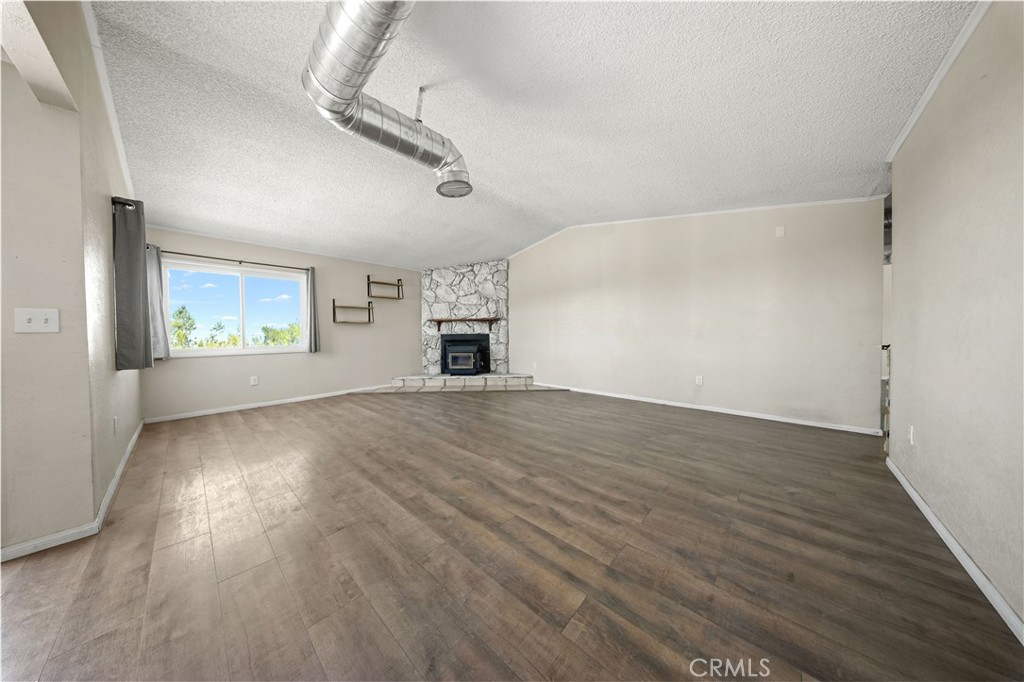 2033 Hollister Road Pinon Hills, CA 92372 - Photo 5 of 25 wooden floor in an empty room with a window