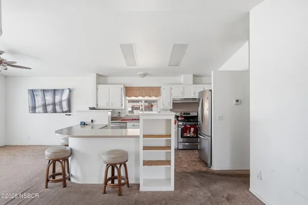 a kitchen with stainless steel appliances granite countertop a sink stove and cabinets